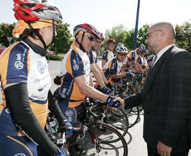 Vojmir Urlep shaking hands with the cyclists, wishing them luck before the tour. 
